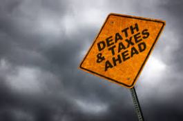 Yellow sign with Death & Taxes Ahead painted on it